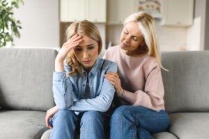 mother comforting daughter as one of many ways to help a loved one with opioid addiction