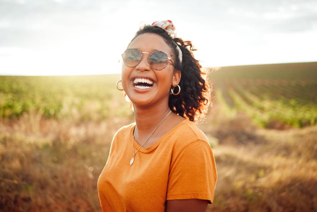 person smiling in an open field after finding the best detox programs in springfield la