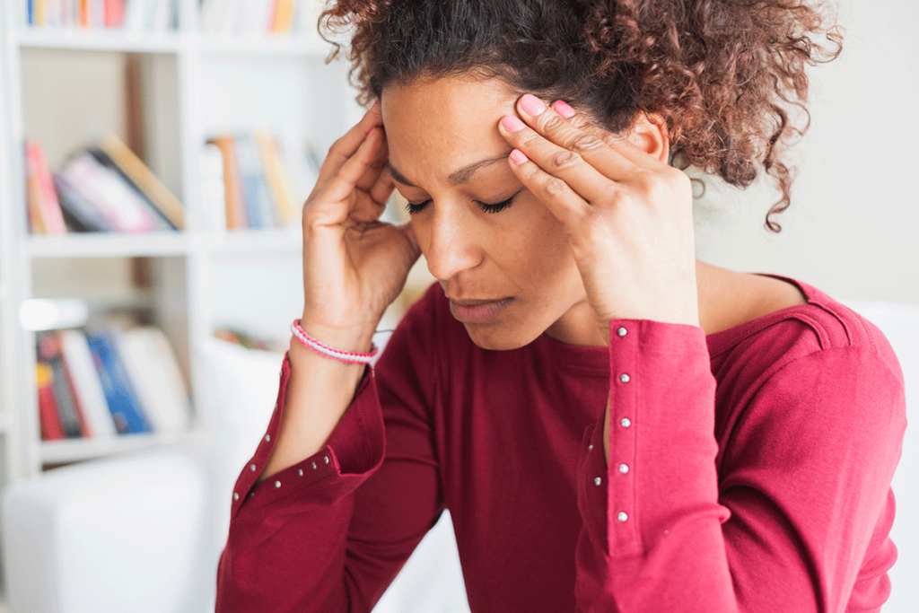 person struggling with headache before receiving nad for migraines