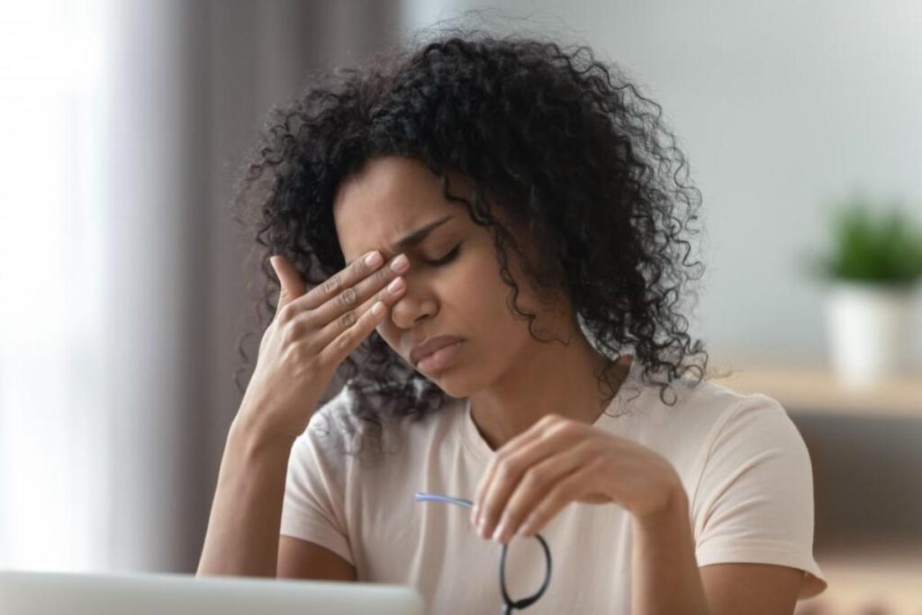 person with headache contemplating nad for migraine relief