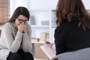 person discussing signs of ptsd in women with counselor