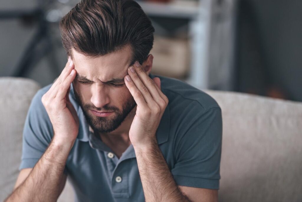 person with severe headache wondering what causes cte
